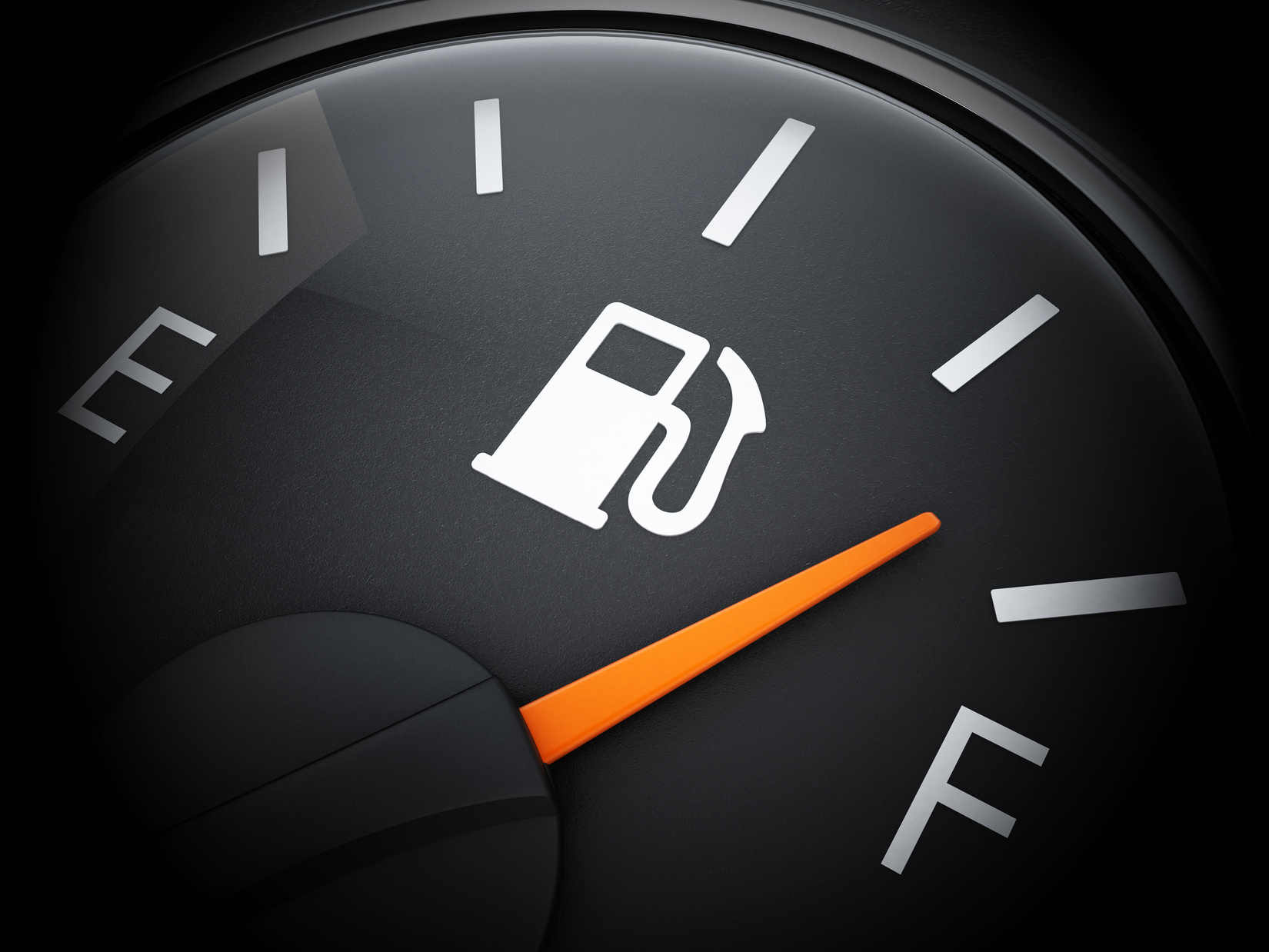 Fuel gauge with needle on E indicating empty car tank